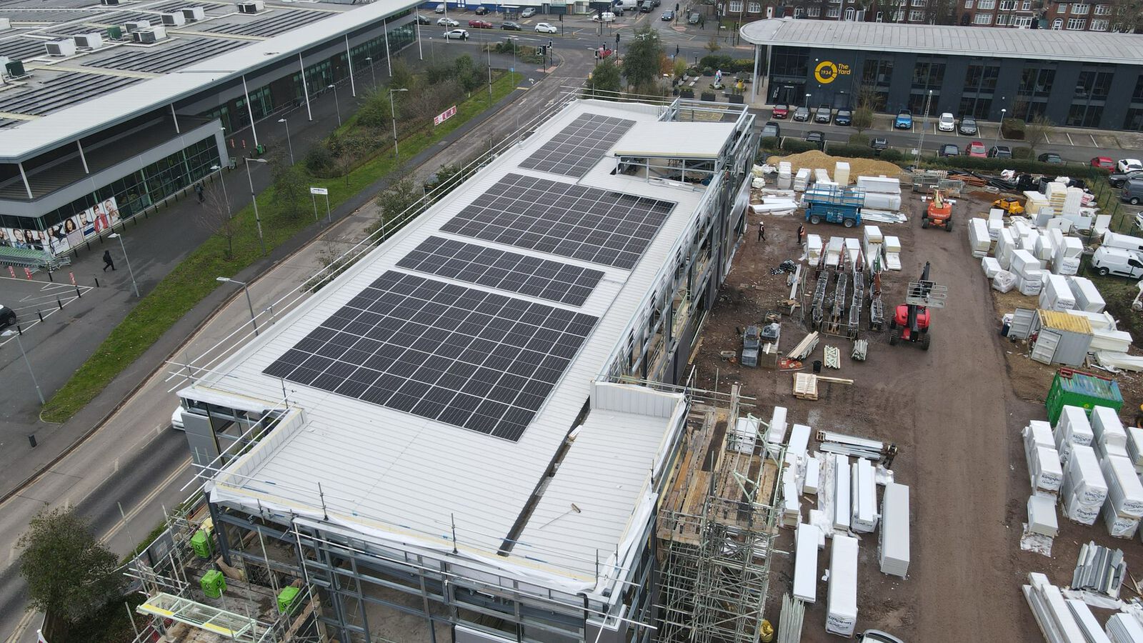 Aerial view of a dock building during solar installation, Exploration Drive